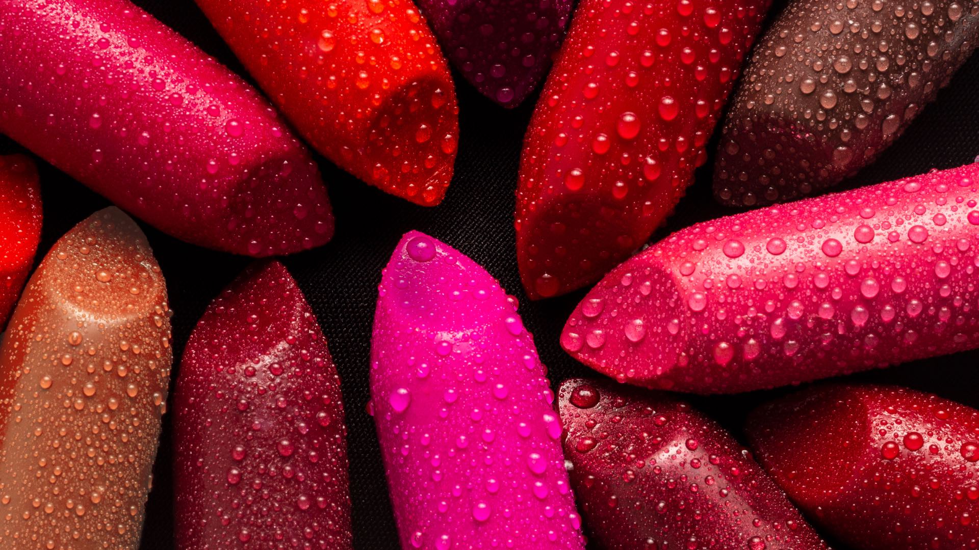 Closeup of lipsticks with water droplets