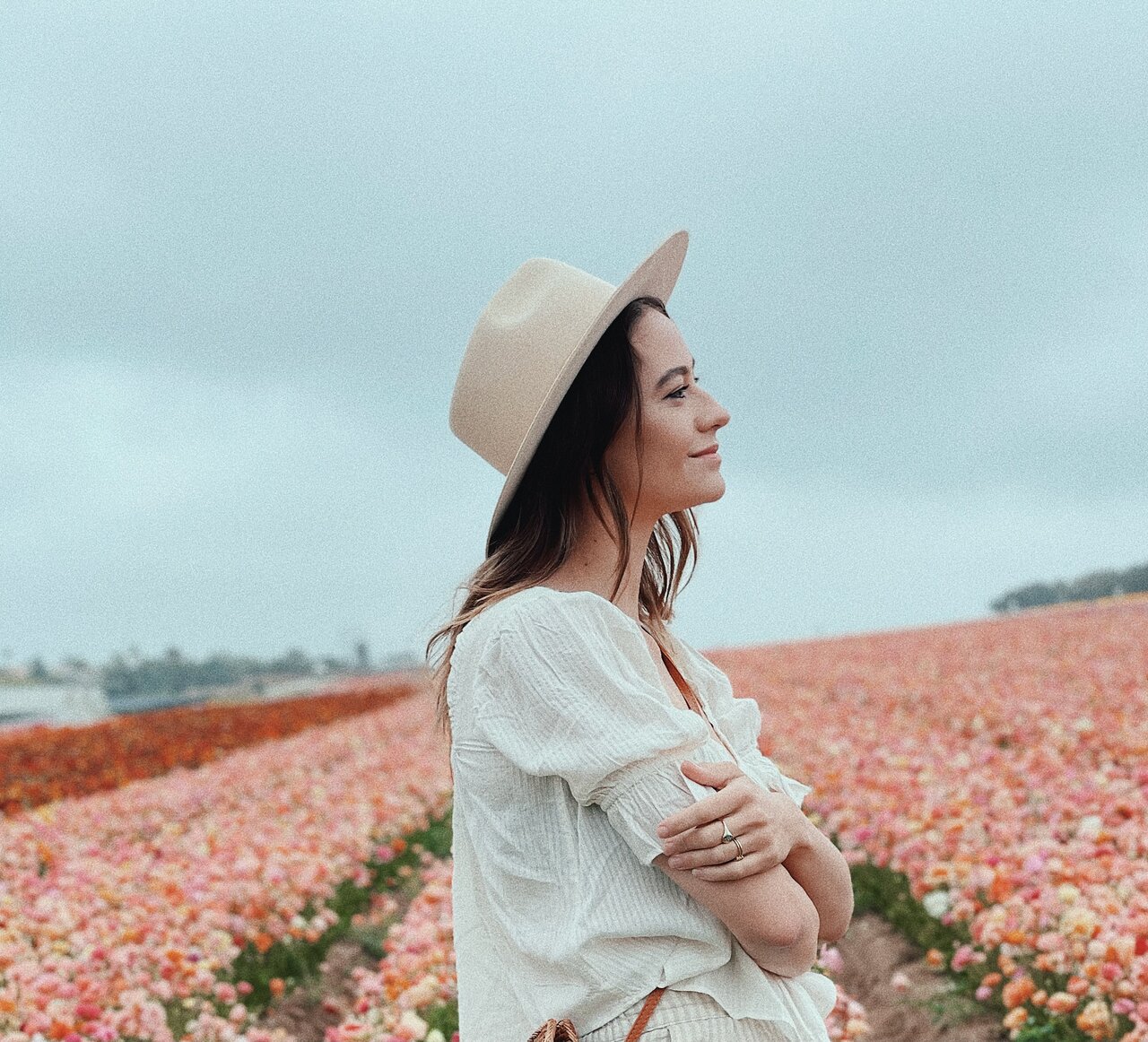 Lexi Delarosa standing in a field of beautiful flowers